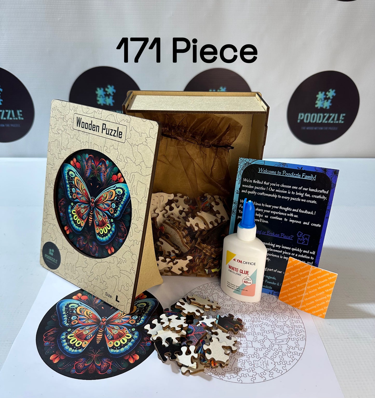 Wooden puzzle set with butterfly design, glue, and packaging on a white surface.